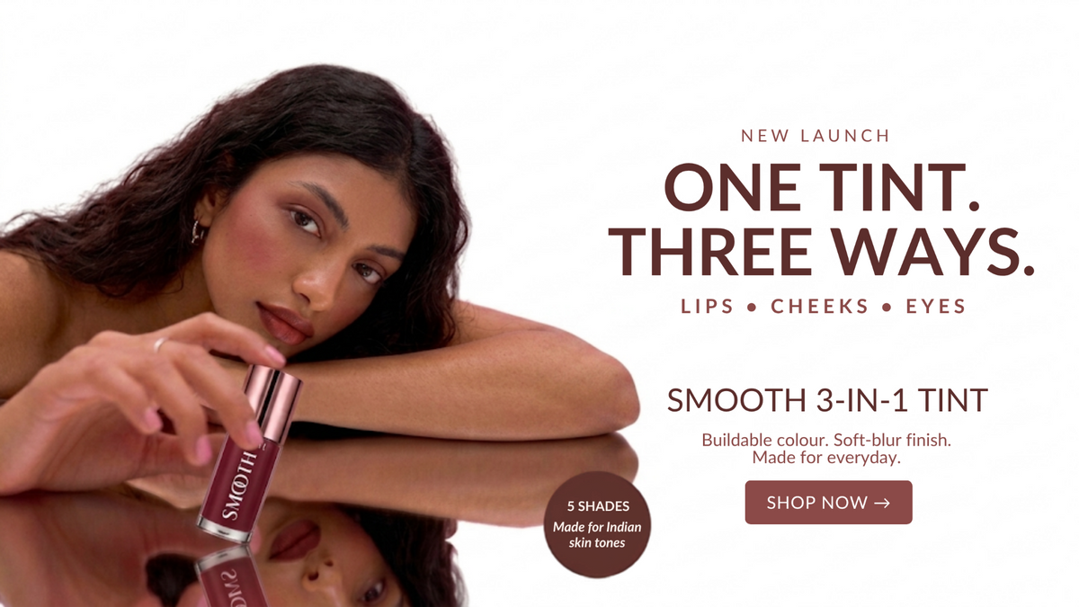 A promotional beauty ad featuring a woman holding a lip tint tube against a white background, with text reading 'ONE TINT. THREE WAYS.